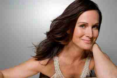 Woman with shiny, healthy hair, demonstrating hair care tips for dry hair.