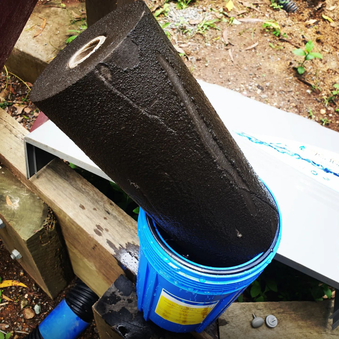 Dirty used whole home water filter compared with clean replacement filter