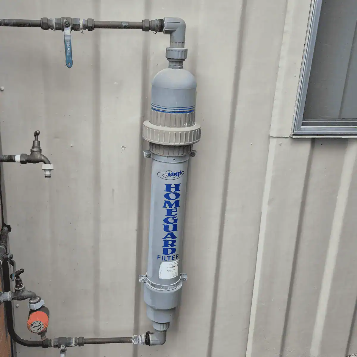 Cheap plastic water filtration system installed outside in Australian conditions