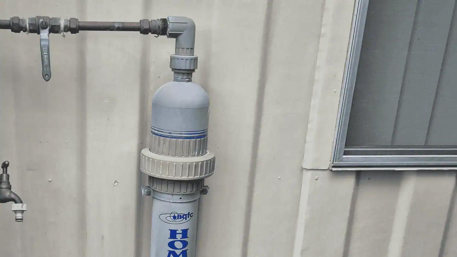 Plastic water filtration unit showing why cover material matters outdoors