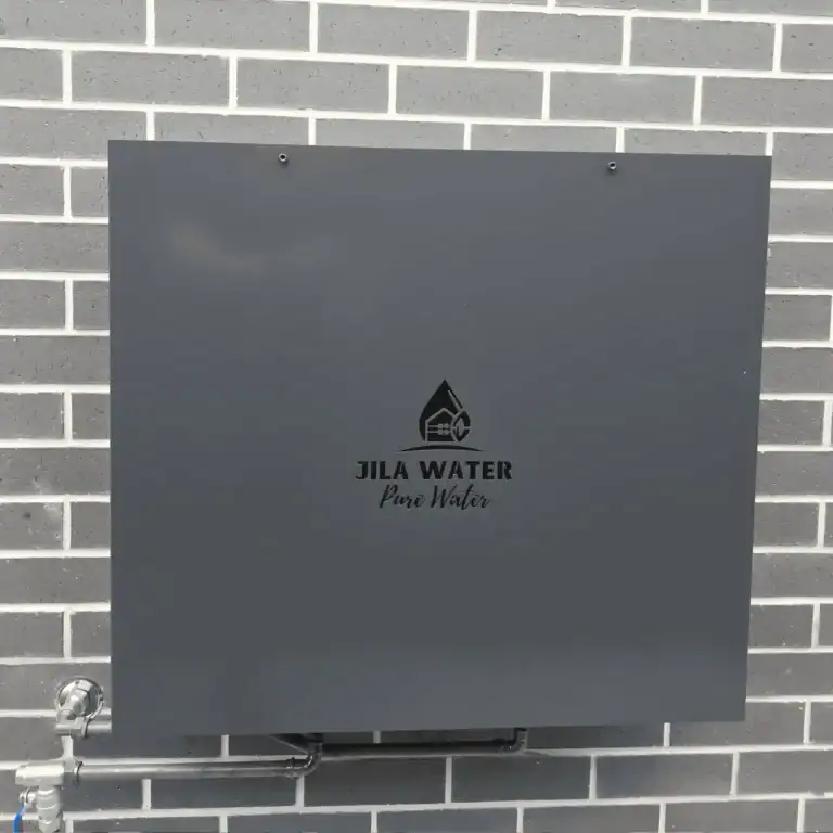 Monument grey Jila Water whole home water filtration system installed on a Brisbane brick wall
