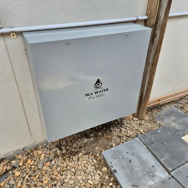 Shale grey Jila Water whole home water filtration system installed on a rendered Brisbane wall